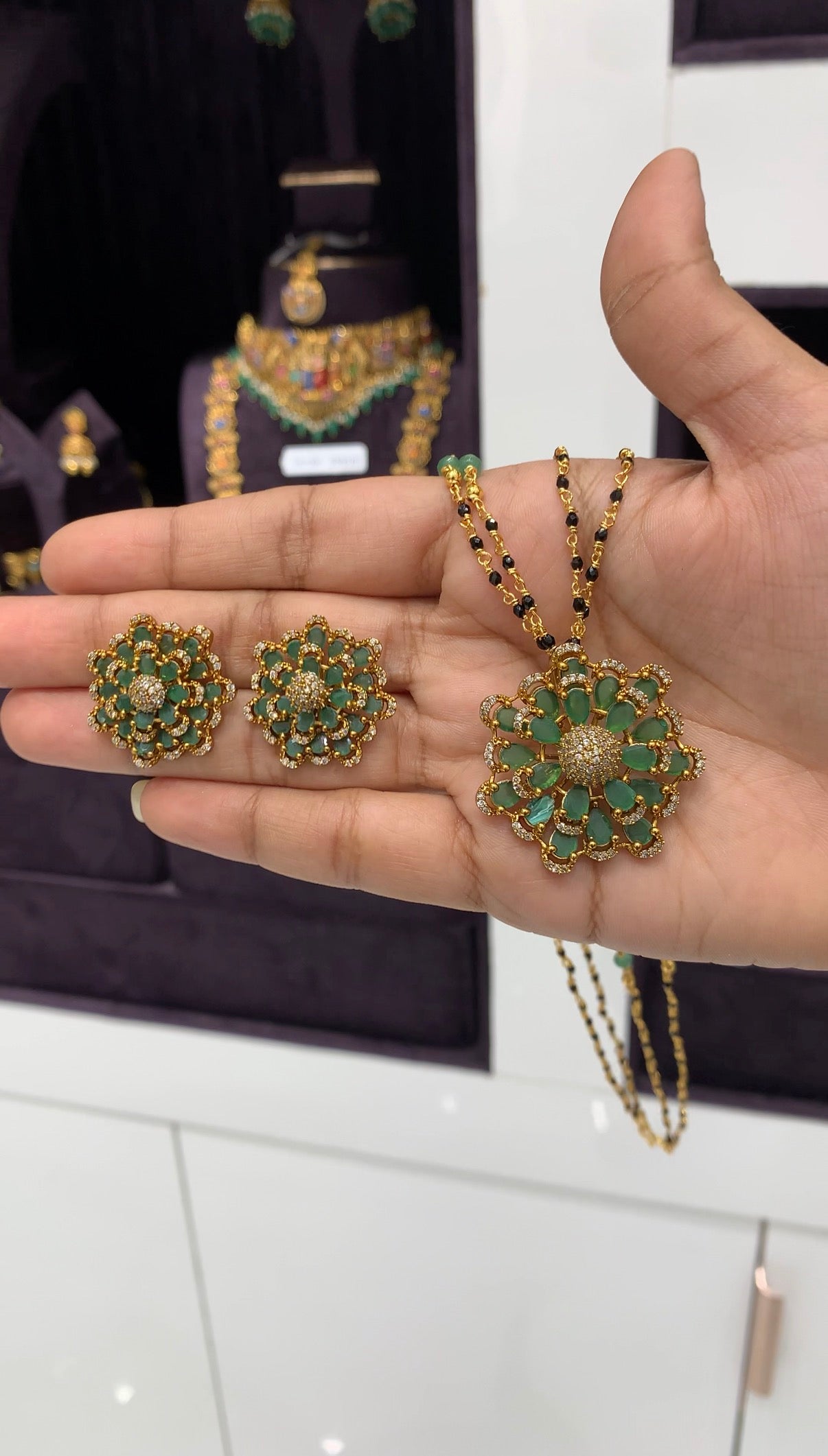 Beautiful 18inch black beads with green stone flower design locket and earrings