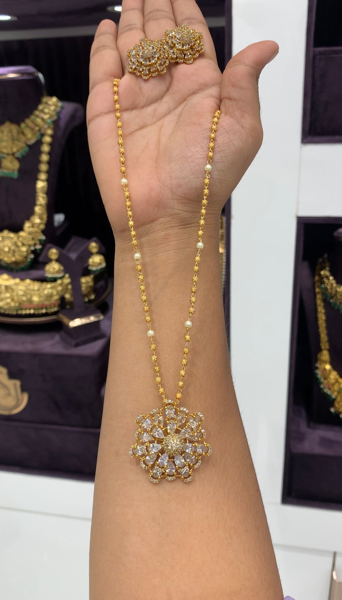 Because white stone pendant set with gold balls chain 18 inchs long