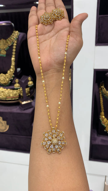 Because white stone pendant set with gold balls chain 18 inchs long