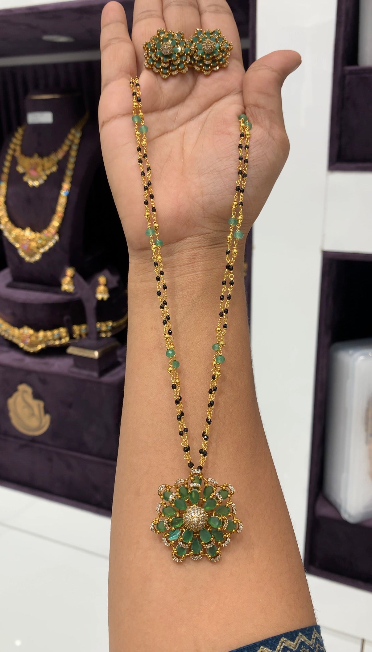 Beautiful 18inch black beads with green stone flower design locket and earrings