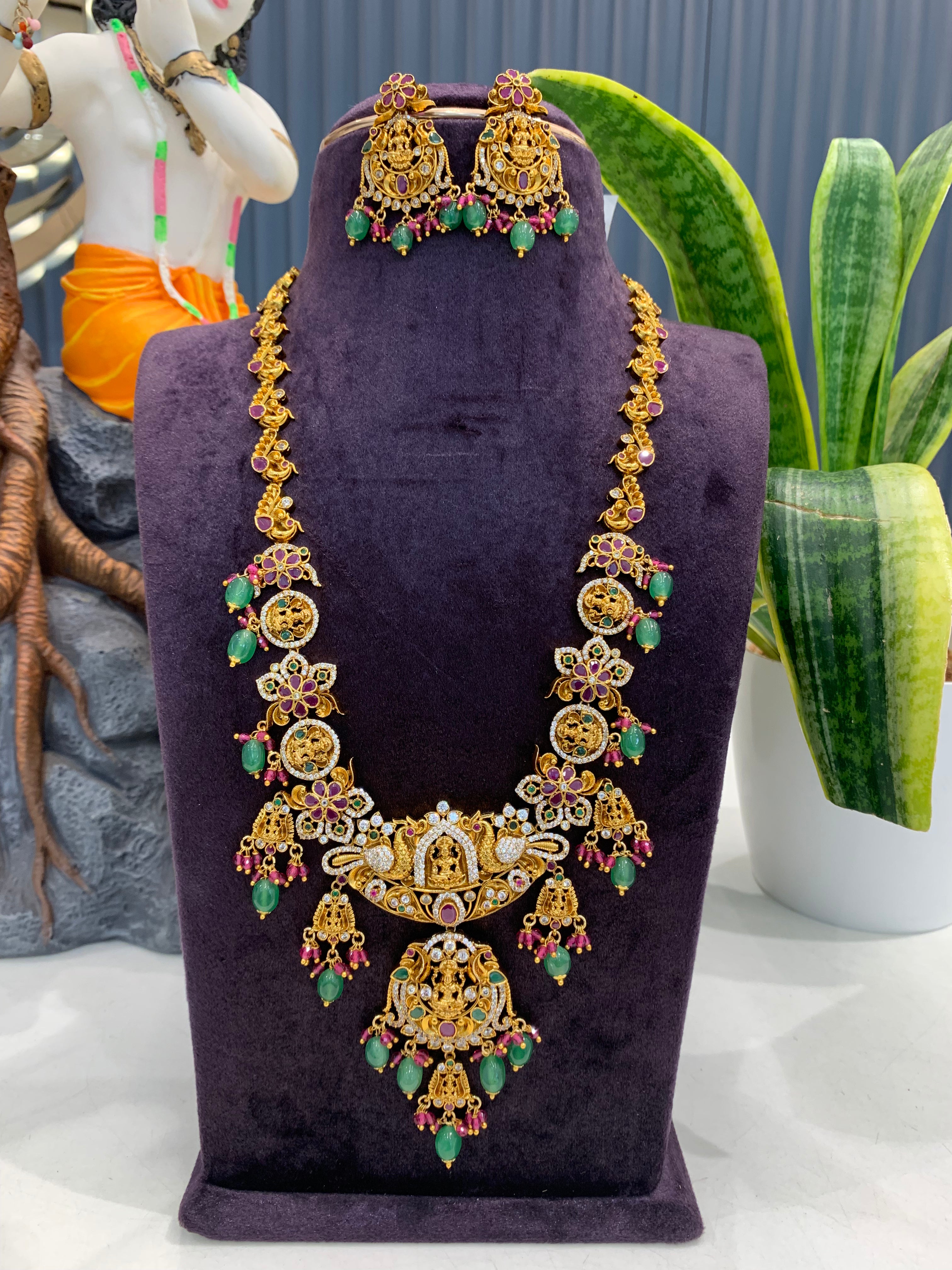 Beautiful Lakshmi devi & pota stone long haram with screwback ear hangings