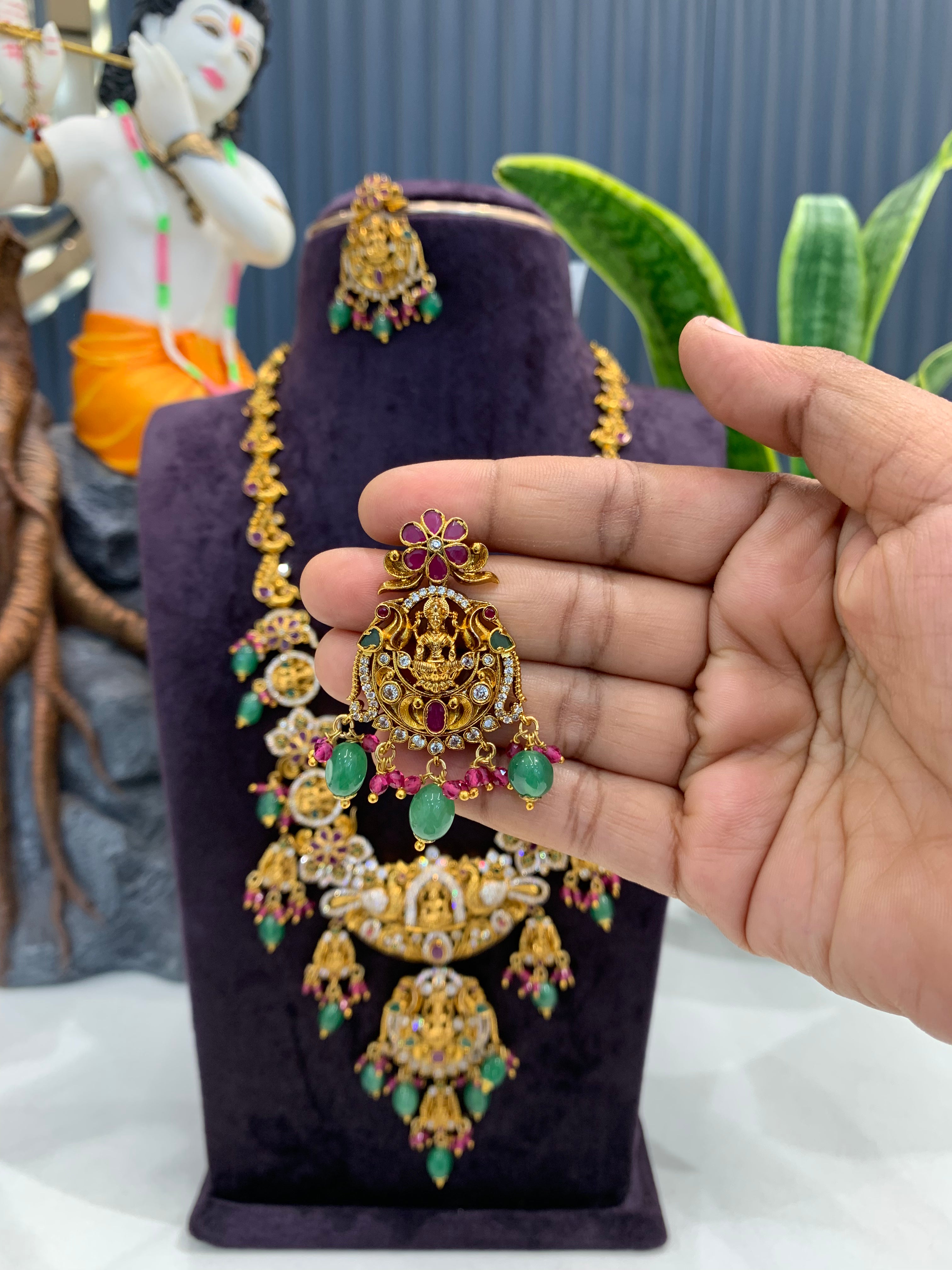 Beautiful Lakshmi devi & pota stone long haram with screwback ear hangings