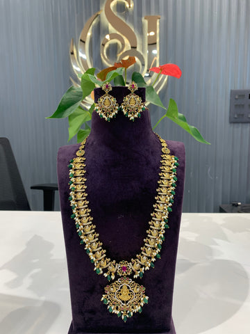 Beautiful cz stone peacock with lakshmi idol design haram and earrings with green beads