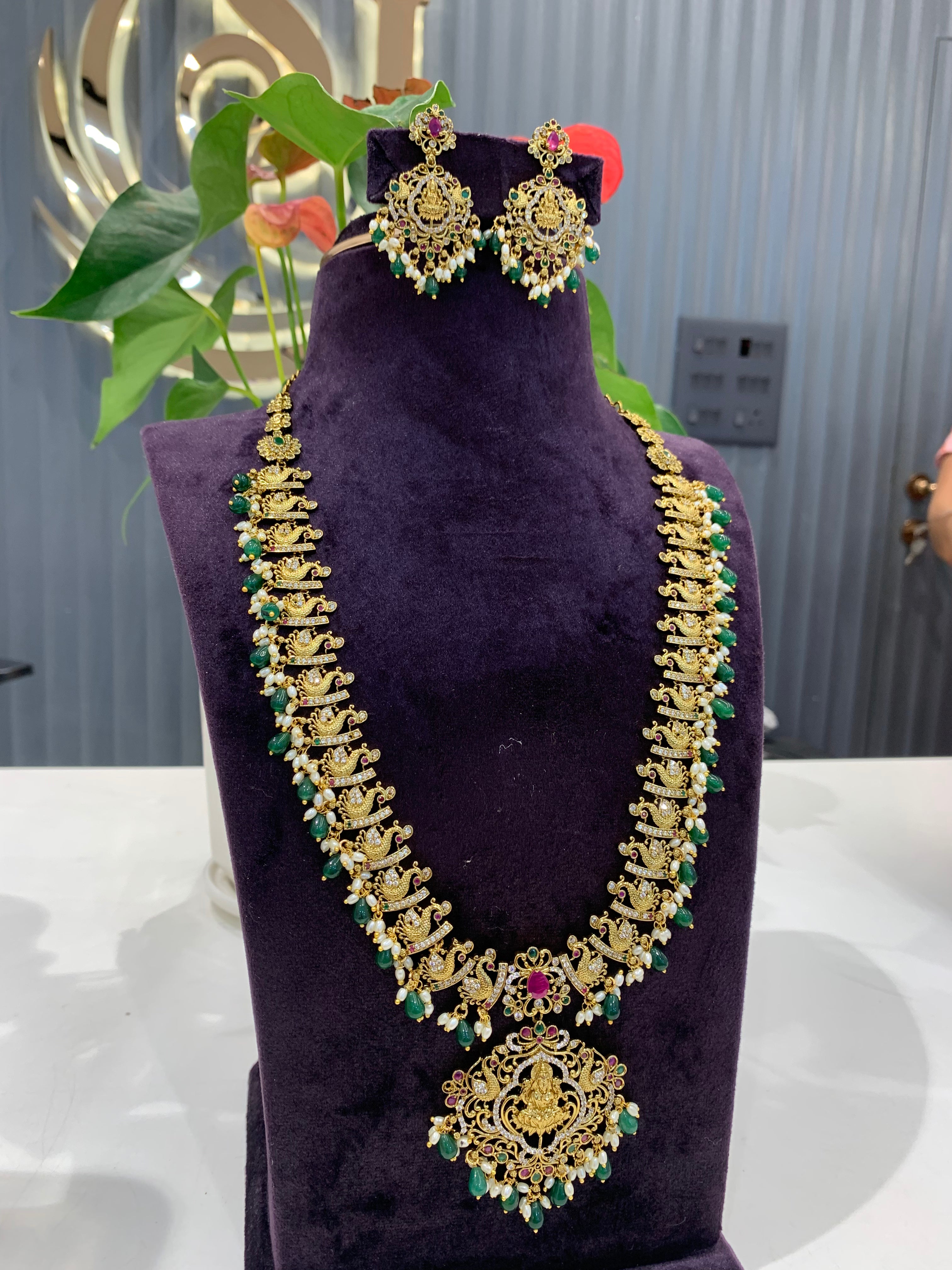 Beautiful cz stone peacock with lakshmi idol design haram and earrings with green beads