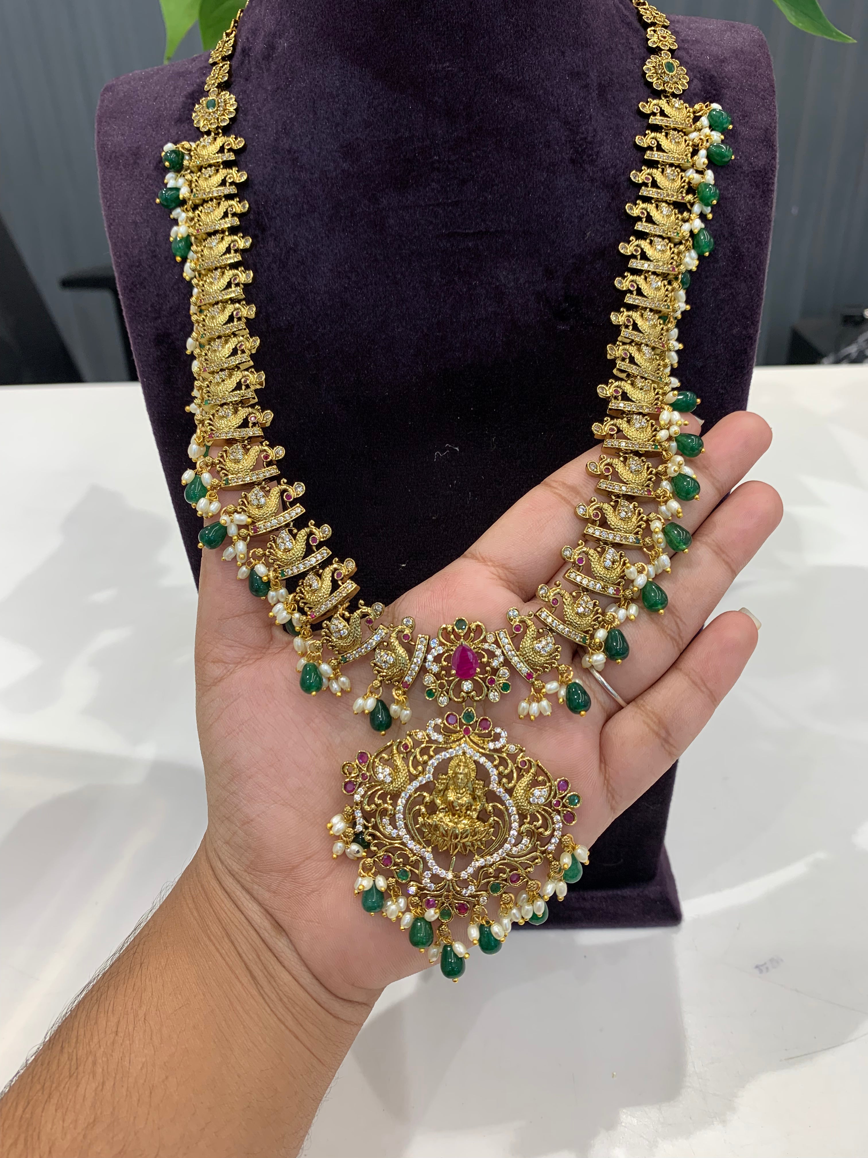Beautiful cz stone peacock with lakshmi idol design haram and earrings with green beads