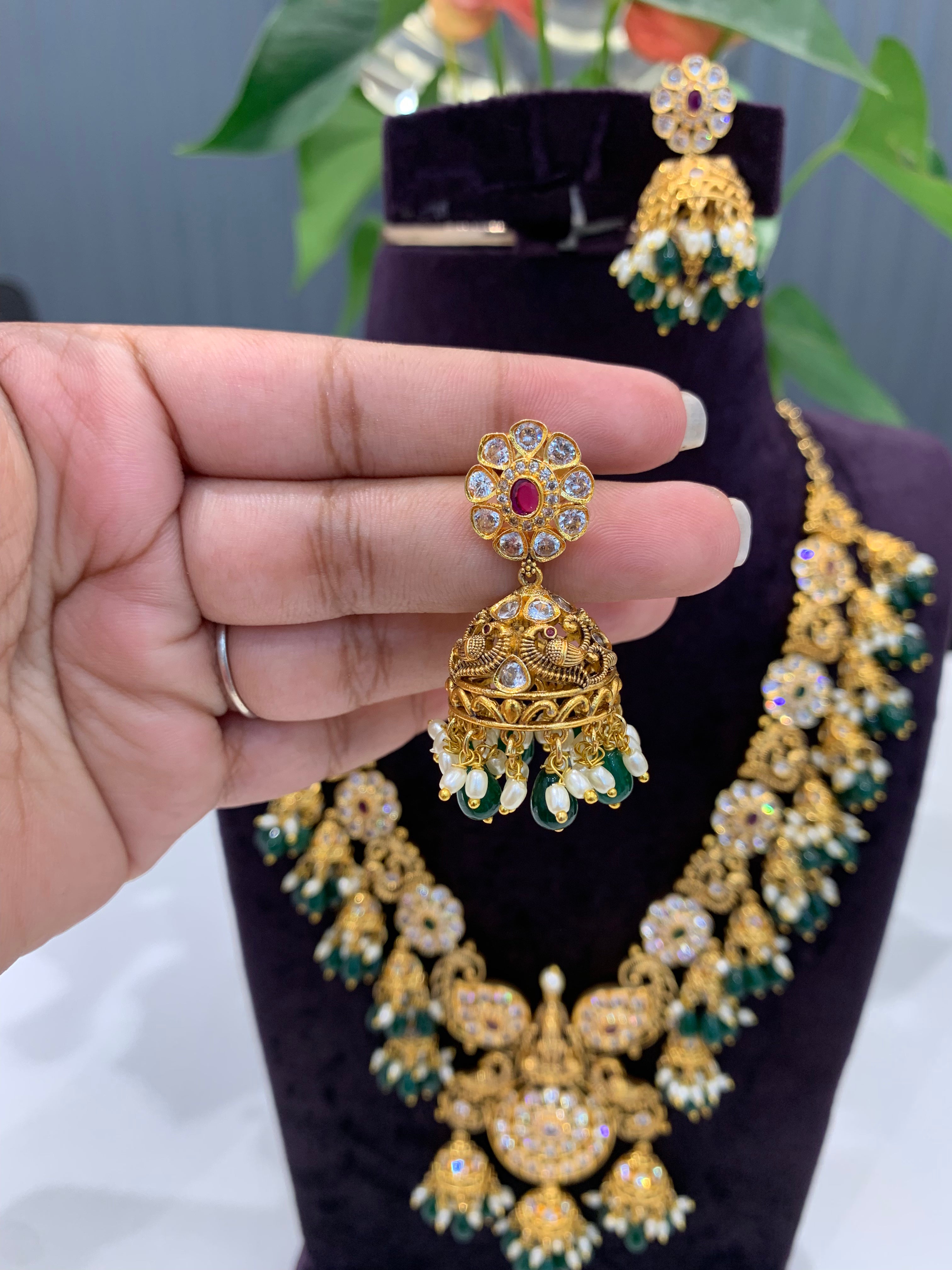 Beautiful peacock floral design necklace and  jumkis with green beads