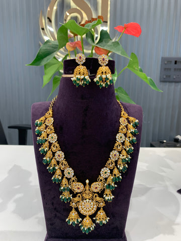 Beautiful peacock floral design necklace and  jumkis with green beads