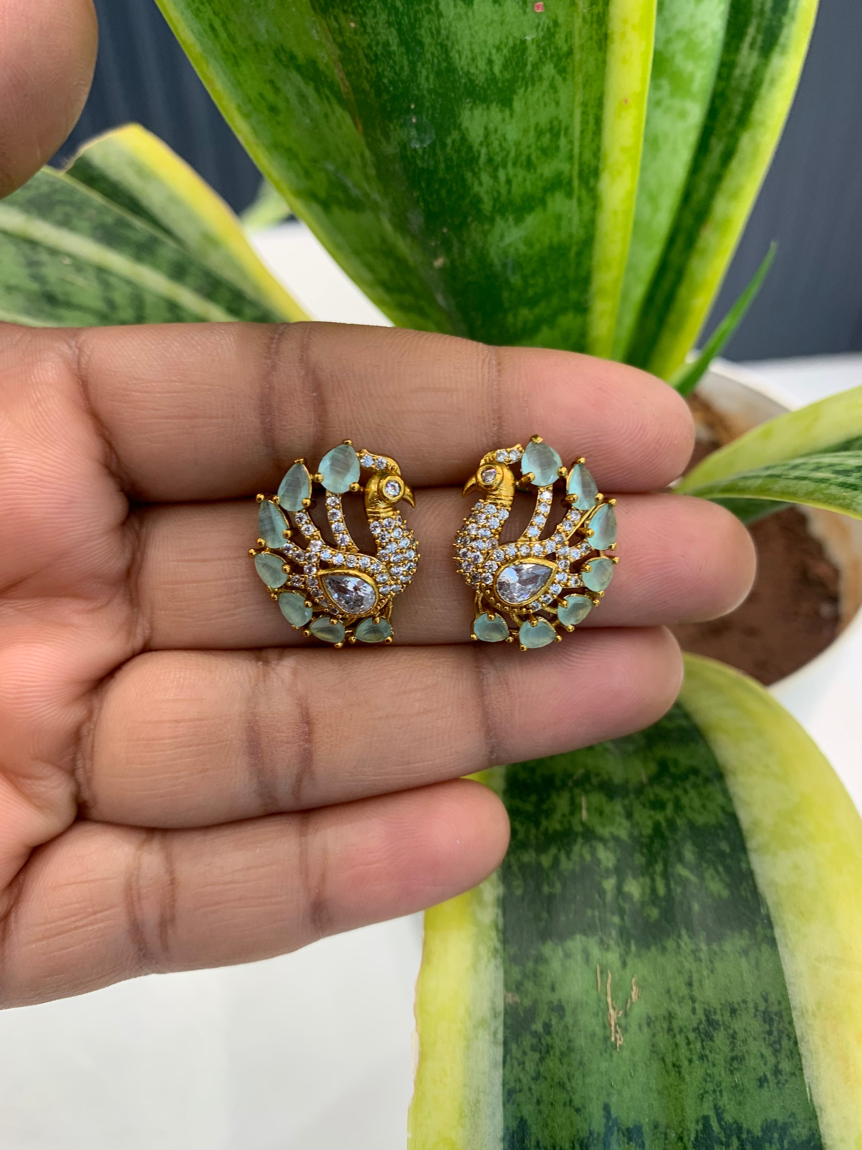 Beautiful peacock design green & white stone studs with pushback