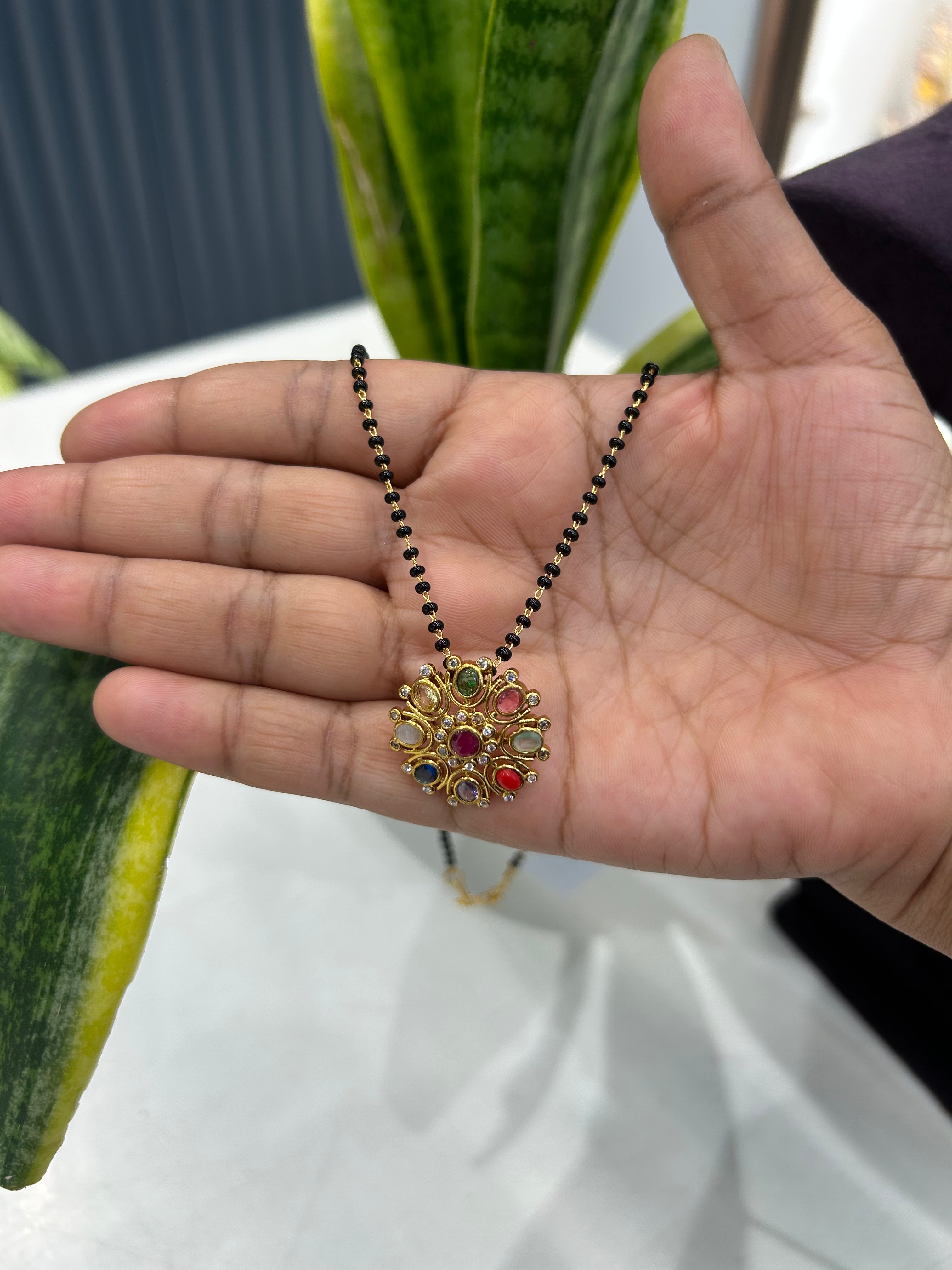 Beautiful navarathna locket with blackbeads chain 18 inchs long