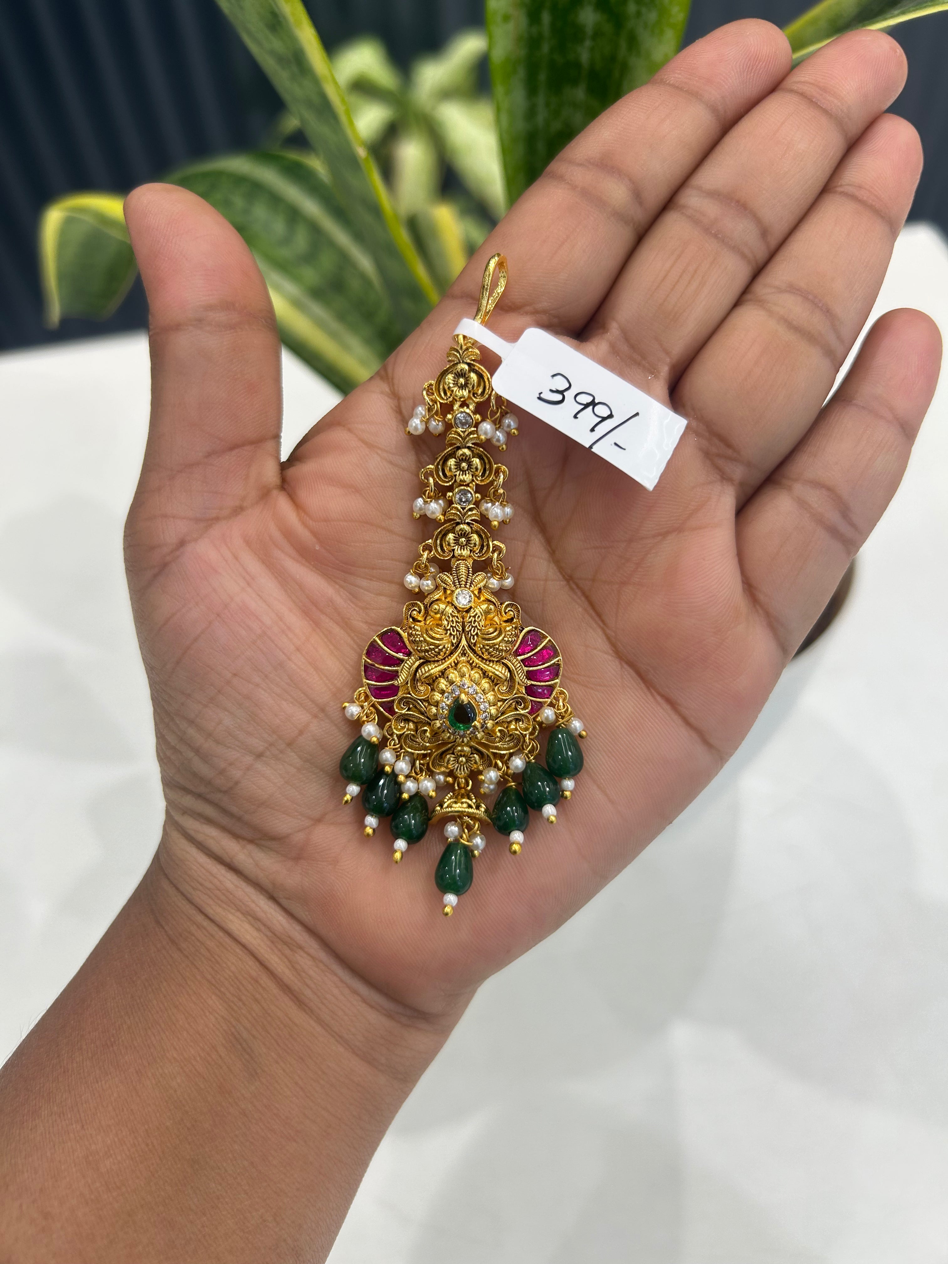 Beautiful jadau stone & peacock design tikka with green beads