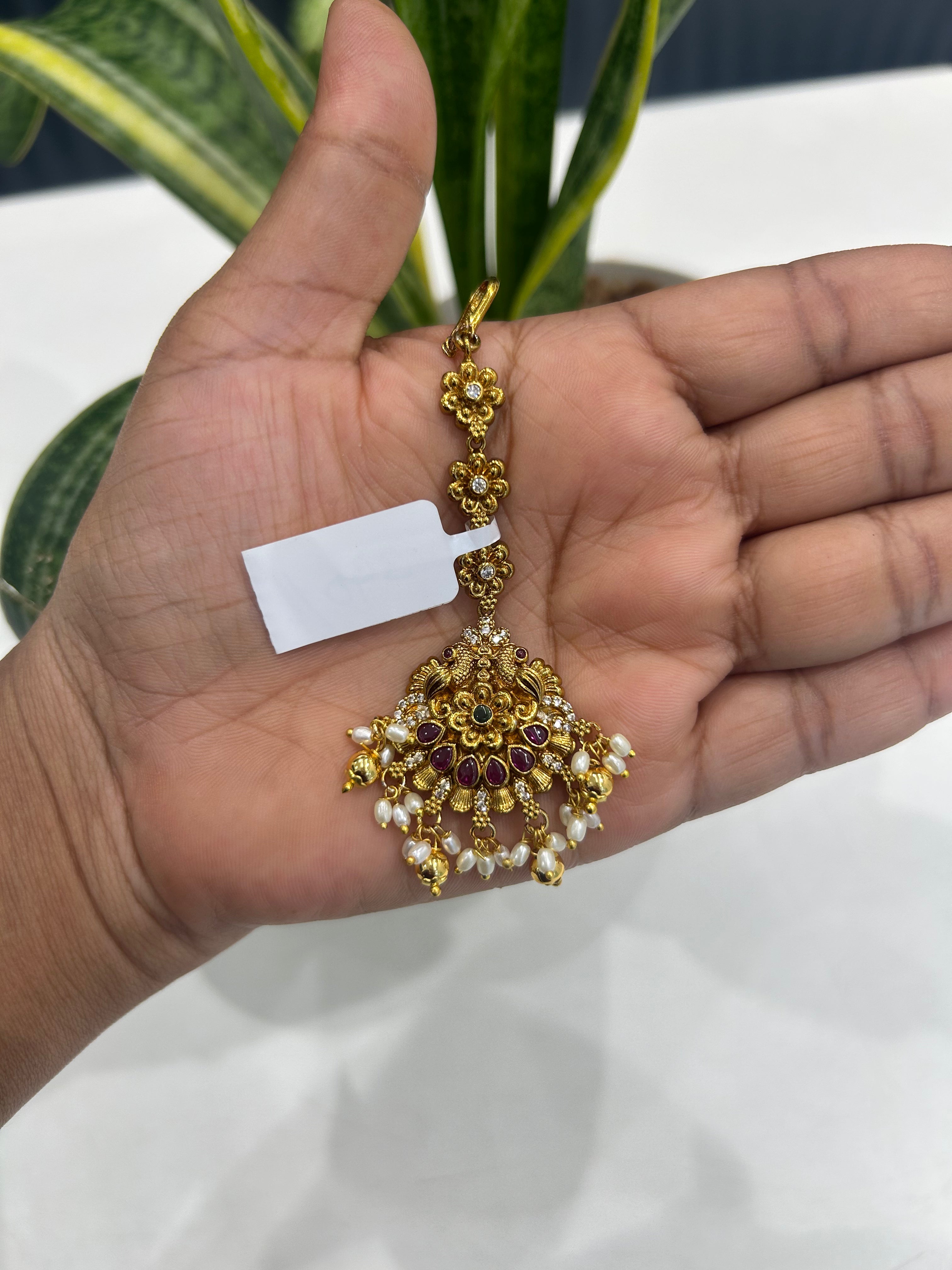 Beautiful peacock design tikka with gold balls